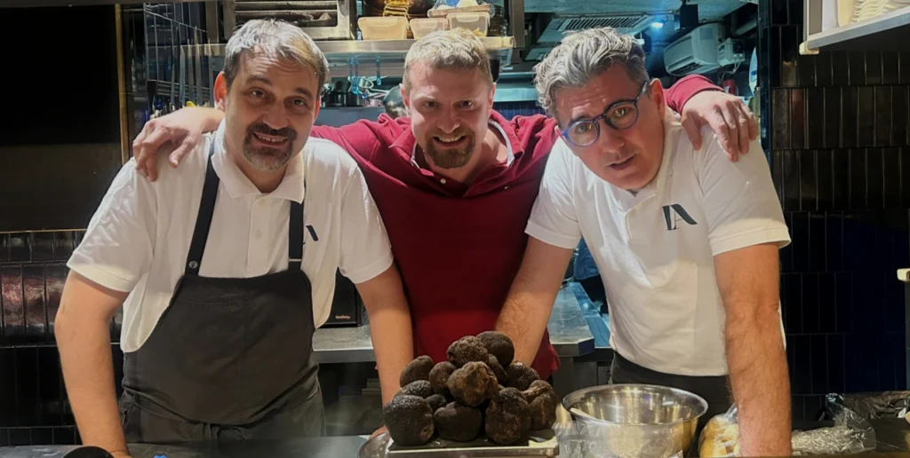 Antoine Piccolo (Center) with two Michelin star chefs. Luca De Berardinis & Alessandro Angelini with Black Truffles on a Scale representing his relationship with them as their supplier of Seasonal Truffles